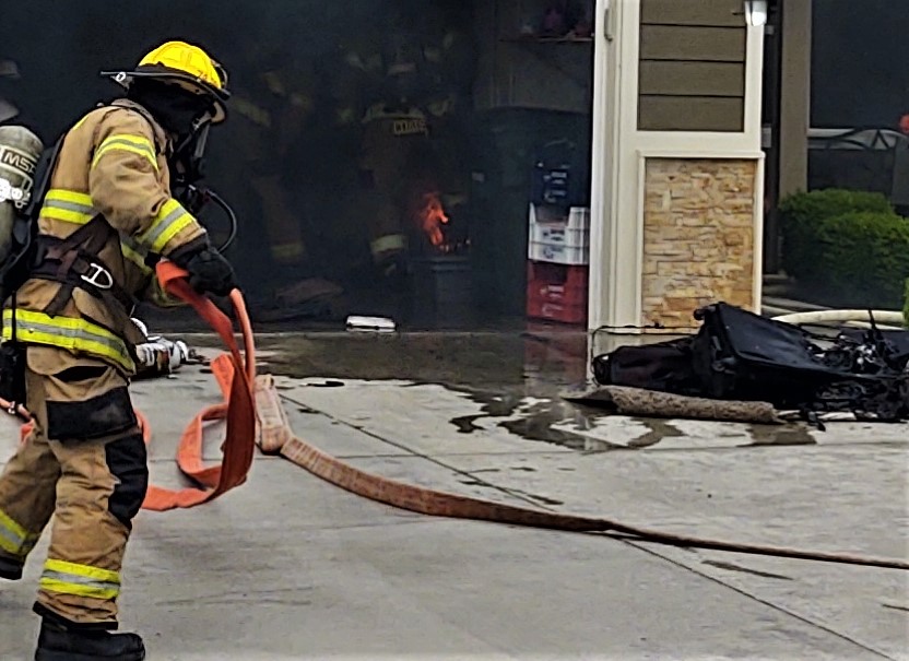 A firefighter with WCFD7 prepares to knock down a fire inside a garage at a residence (June 4, 2020). Photo: My Ferndale News