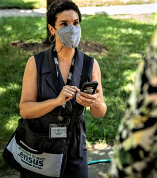 US Census worker collecting data while going door-to-door. Source: US Census Bureau