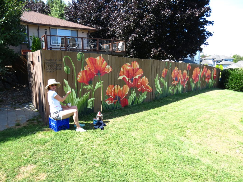 Bellingham mural artist Khara Ledonne puts on the finishing touches to a 50-foot fence mural in Ferndale near N Beulah Avenue and Thornton Street (August 26, 2020). Photo: My Ferndale News