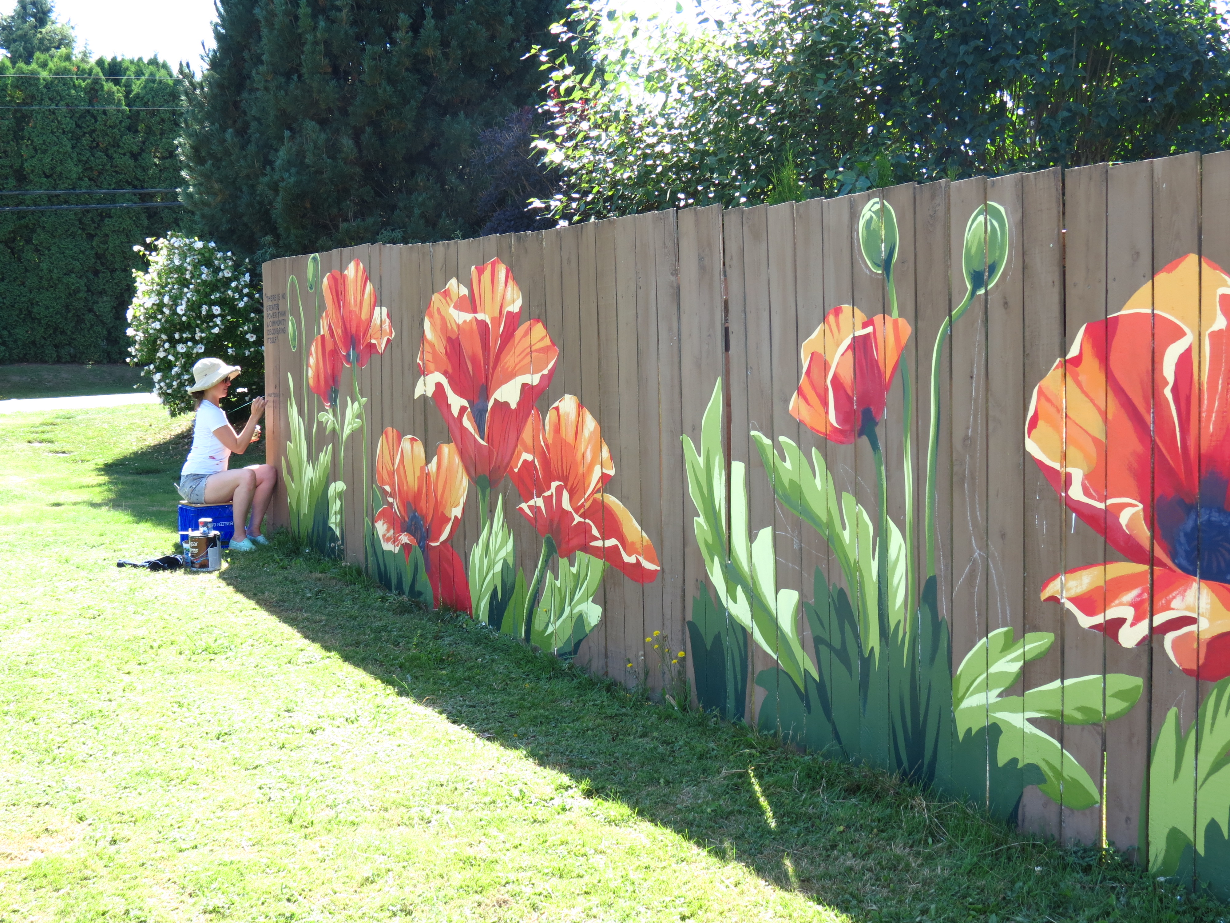 Bellingham mural artist Khara Ledonne puts on the finishing touches to a 50-foot fence mural in Ferndale near N Beulah Avenue and Thornton Street (August 26, 2020). Photo: My Ferndale News