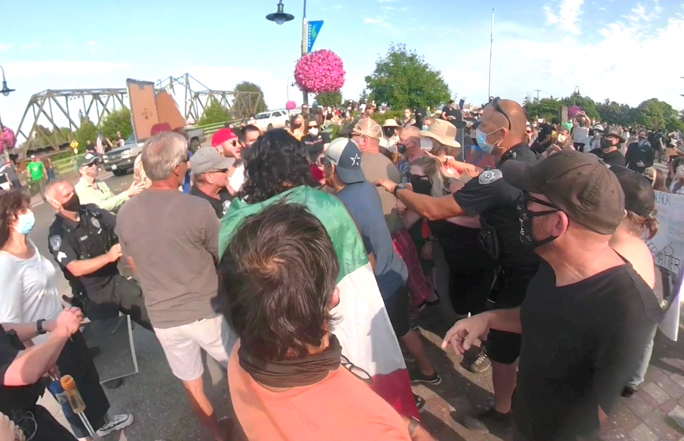 Still from a video showing Ferndale Police officers arriving to break up a scuffle during 2 rallies in downtown Ferndale (July 31, 2020).