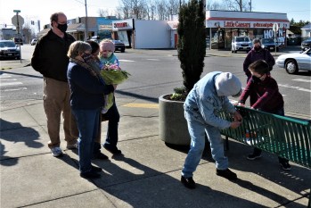 Chief Michael Knapp's family looks on as his grandson assists with the installation of a plaque on a bench dedicated in Knapp's memory. (February 26, 2021). Photo: My Ferndale News