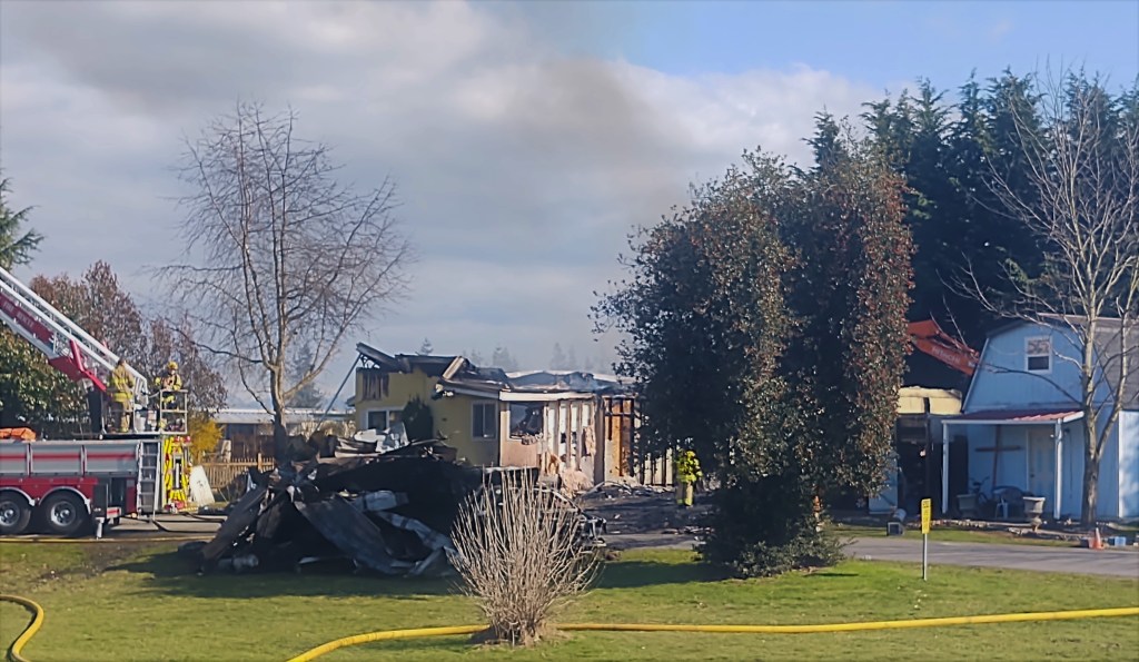 North Whatcom Fire and Rescue firefighters continue working after knocking down a residential fire (March 30, 2021). Photo: Whatcom News
