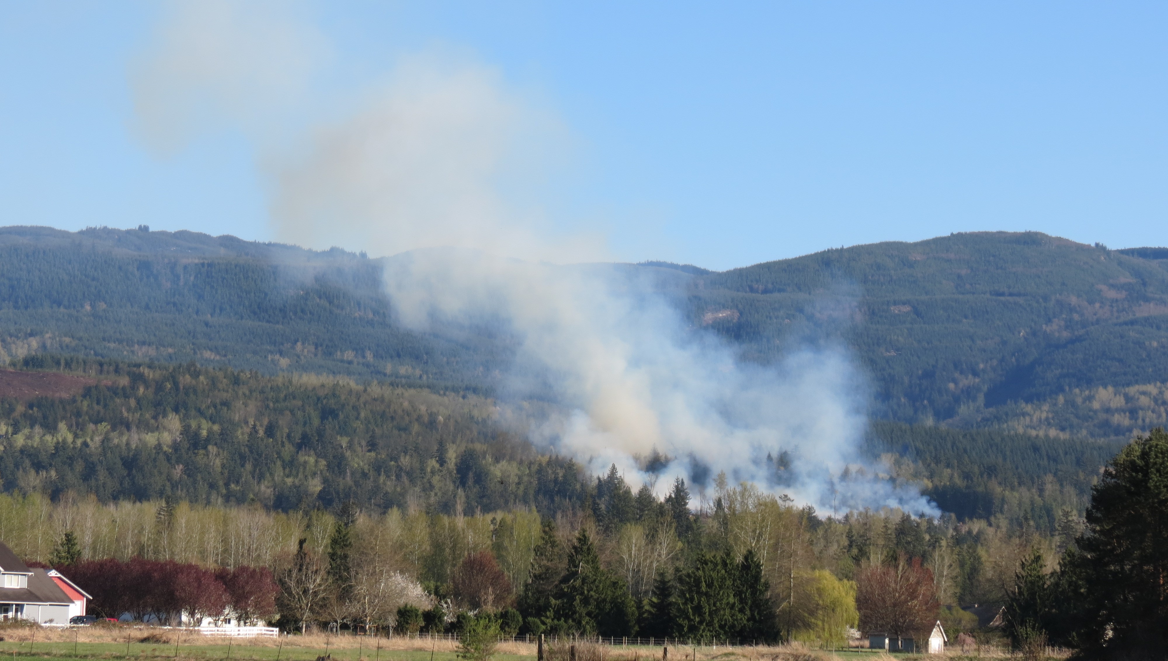 Smoke rises from an outside fire in the 3100 block of Mt Baker Highway (April 18, 2021). Photo: Whatcom News