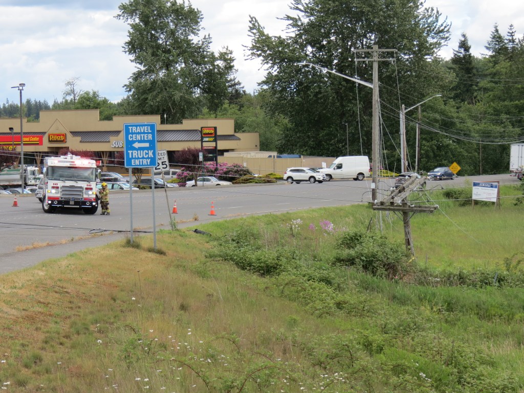 Scene of power lines across Main Street east of I-5 after 1 or more poles collapsed when a semi-truck trailer snagged a wire (May 28, 2021). Photo: Whatcom News