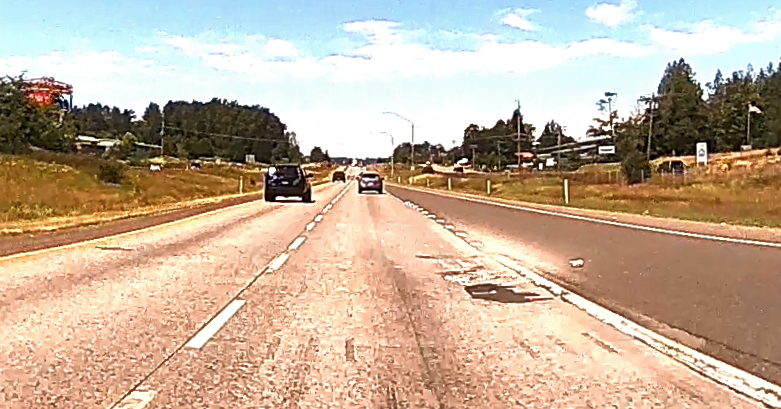 Debris is visible around a concrete patch on northbound I-5 near Slater Road (June 21, 2021). Whatcom News dashcam photo