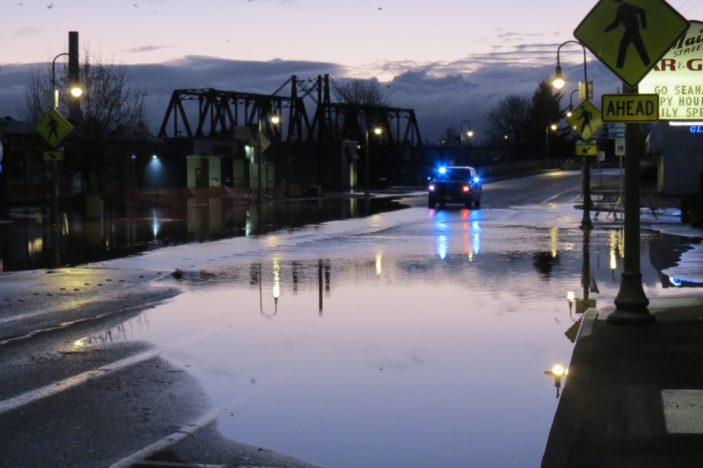 Floodwaters seen spilling over onto Main Street at 1st Avenue (November 15, 2021). Photo: Whatcom News