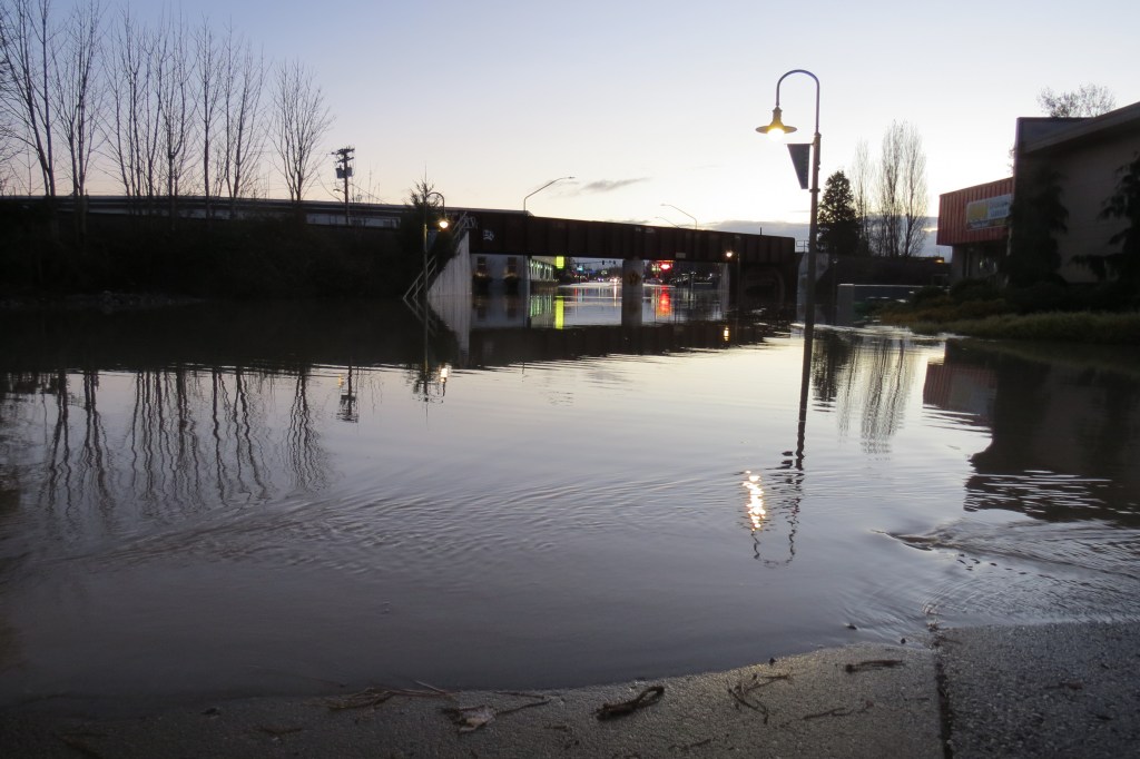 Floodwaters over Main Street at east end of Pioneer Bridge looking east (November 16, 2021). Photo: Whatcom News