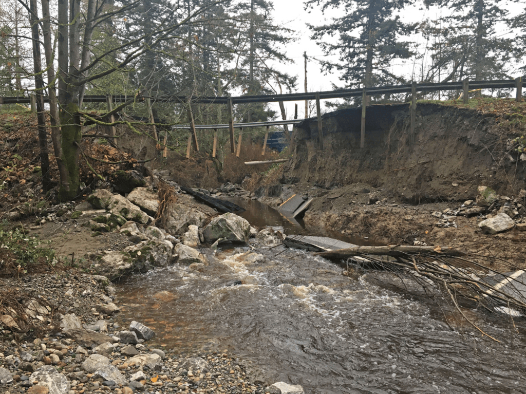 Washed out section of Birch Bay-Lynden Road as seen from the California Creek. Source: Whatcom County Public Works