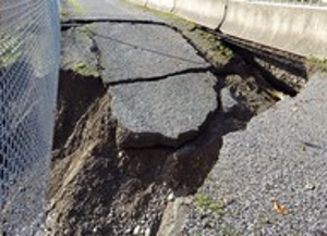 A washed-out section of the pedestrian pathway and shoulder of Everson Road west of the bridge. Source: WSDOT