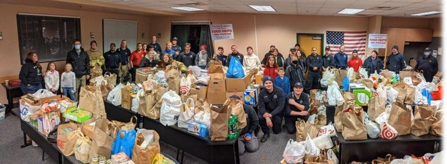 Helpers with Whatcom 7 Firefighters and the Ferndale Police Department pose with food collected for the Ferndale Food Bank (December 15, 2021). Photo courtesy of Whatcom 7 Firefighters