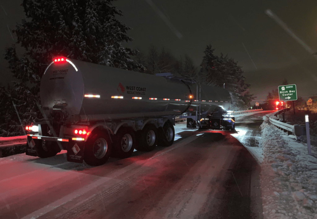 A semi-truck puts on chains after becoming stuck on southbound I-5 exit to Grandview Road with snow and ice on the road (January 4, 2022). Photo courtesy of Washington State Patrol