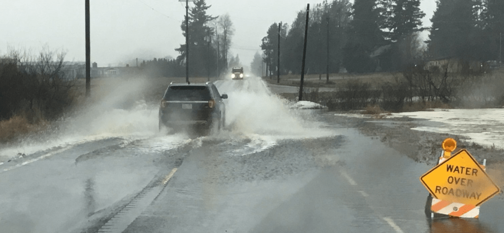 Vehicles drive through water over the roadway on E Pole Road (SR544) between Hannegan Road & Everson Goshen Road before the road was closed to traffic (January 12, 2022). Photo courtesy of WSDOT