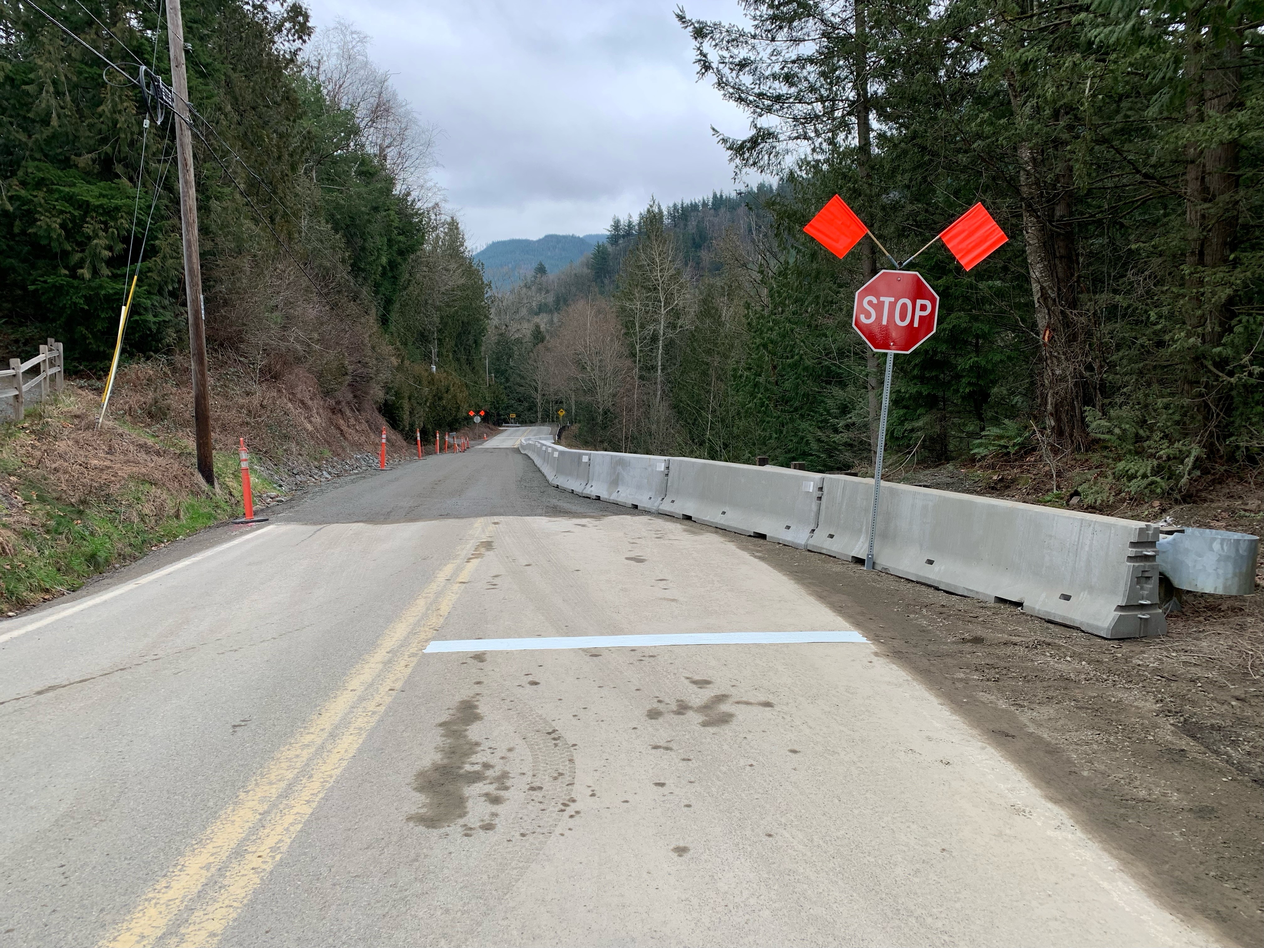 Temporary single gravel lane on S Pass Road with stop signs for alternating directions of traffic (February 18, 2022). Source: Whatcom County Public Works