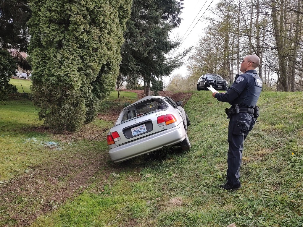 A Ferndale Police officer at the scene of a rollover crash on Malloy Road (April 14, 2022). Photo: Whatcom News