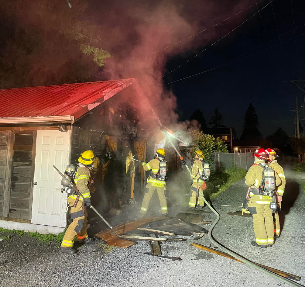 Firefighters extinguish what appeared to be 1 of 2 intentional fires in the Sunnyland neighborhood in Bellingham (June 30, 2022). Photo courtesy of Bellingham Fire Department