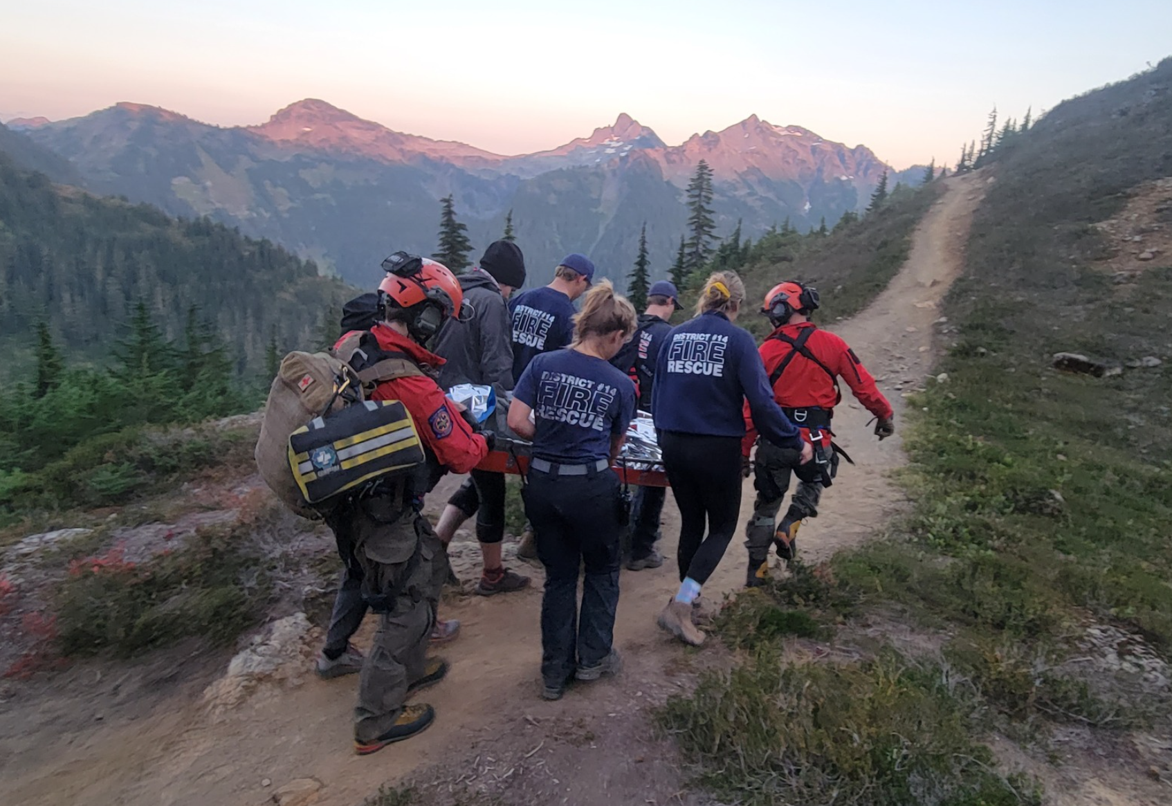 Rescuers carry an injured hiker on the Yellow Aster Butte Trail to where a Naval Air Station Whidbey Island helicopter would arrive to transport to a hospital (September 19, 2022). Photo courtesy of WCFD14