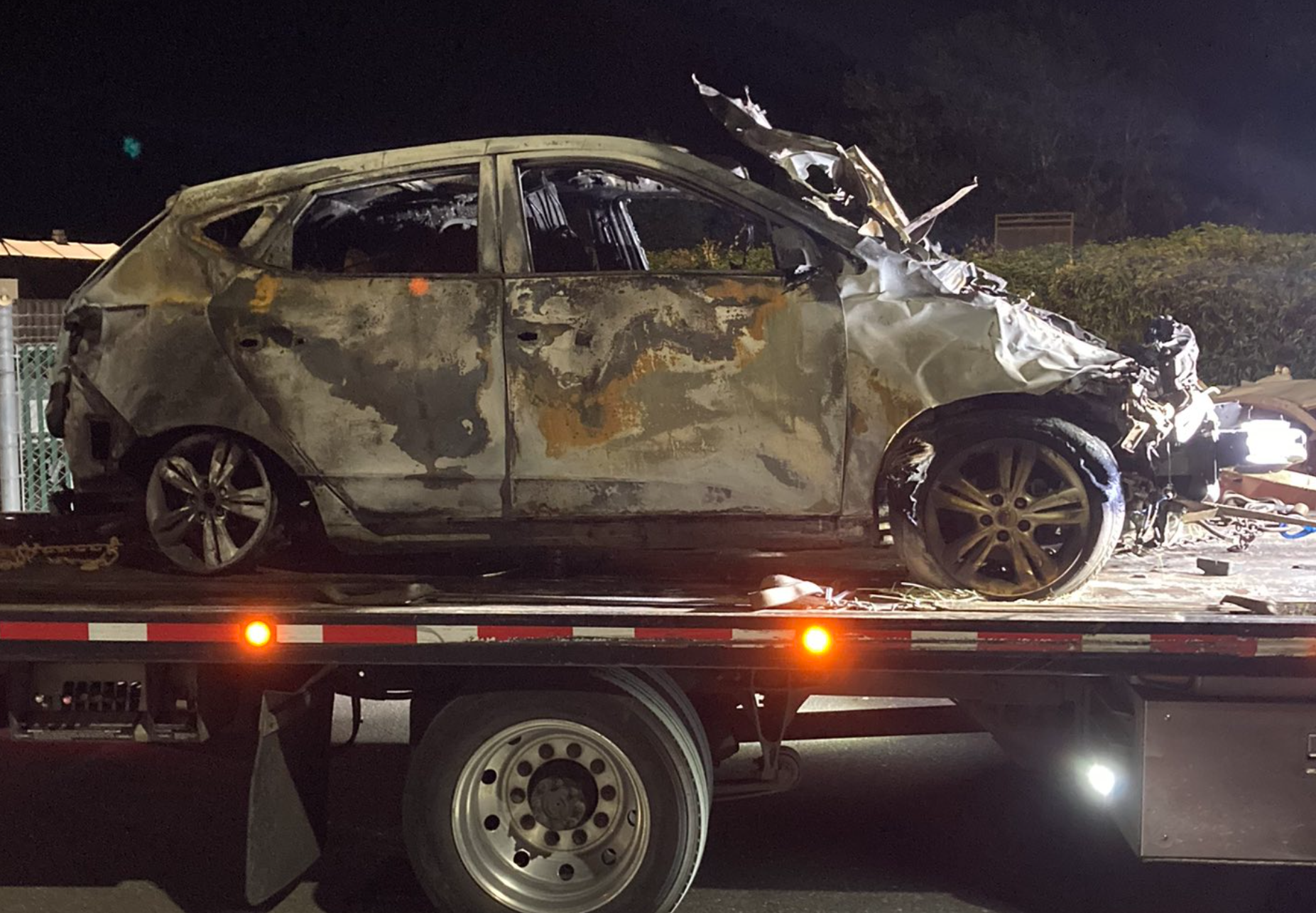 A Hyunda SUV involved in a pursuit that crossed into Canada where it crashed and caught fire is seen being hauled on a trailer (July 22, 2023). Photo courtesy of WSP