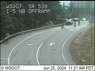 Scene of broken glass strewn across I-5 off-ramp at Meridian Street (WSDOT traffic camera)