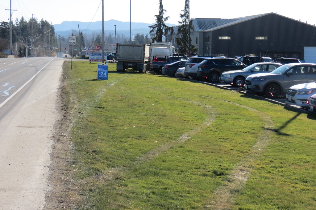 Scene of dump truck and trailer crash into parking lot off Hannegan Road (February 12. 2025). Photo: Whatcom News