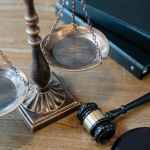 justice scales and gavel on wooden surface