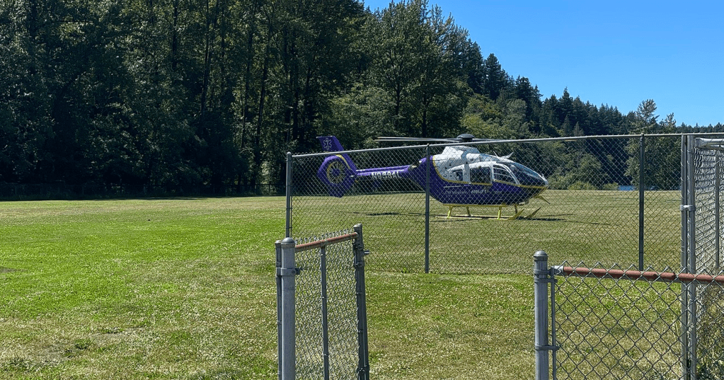 Airlift Northwest helicopter sits at a landing zone in Lake Padden Park during a patient transport (July 1, 2025). Photo: South Whatcom Fire Authority