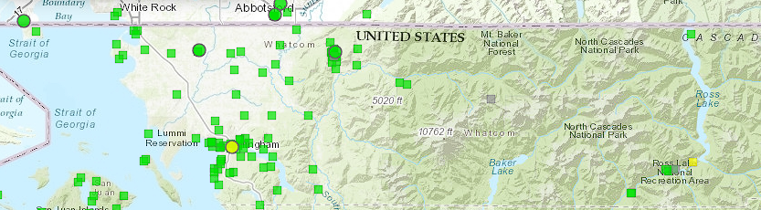 Map showing air quality monitoring stations in Whatcom County, Washington, with various markers indicating air quality levels.