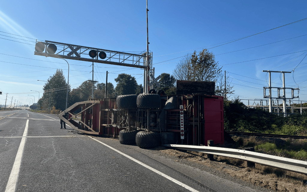 Overturned farm trailer impacts traffic on E Badger Road